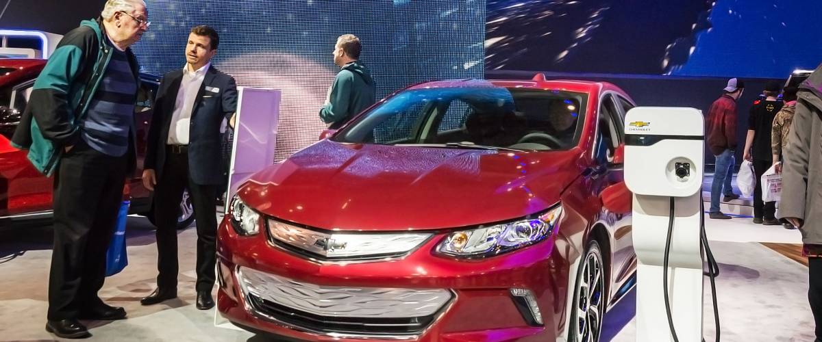 Toronto, Canada - 2018-02-19 : Visitors of 2018 Canadian International AutoShow beside the new 2018 Chevrolet Volt electric car