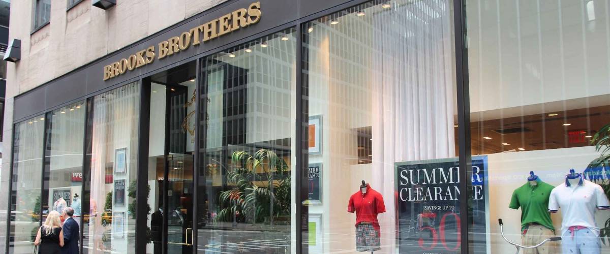 NEW YORK, USA - JULY 4, 2013: People walk by Brooks Brothers fashion store in 6th Avenue, New York. Brooks Brothers is one of oldest clothes store chains in the USA, founded in year 1818.