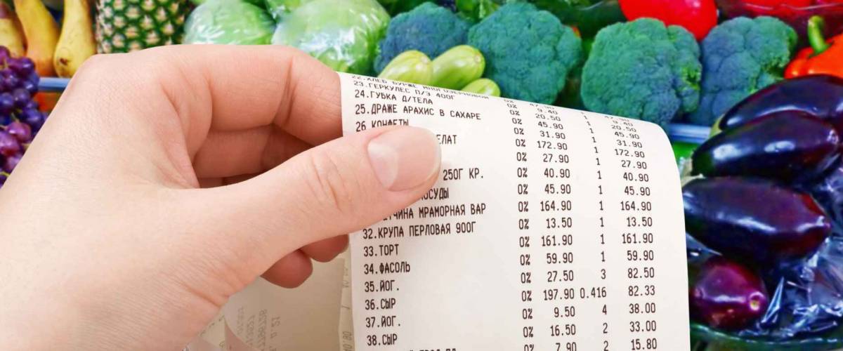 hand holds the check from supermarket