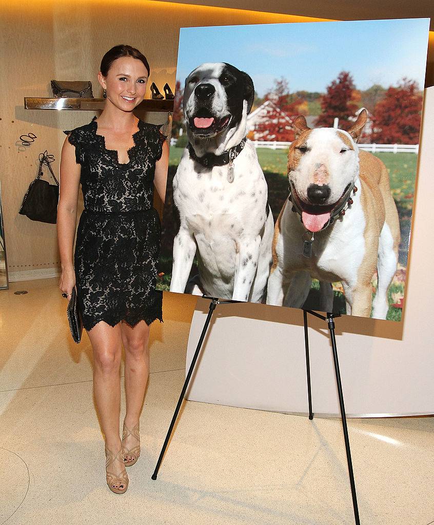 Georgina Bloomberg poses next to a photo of her dogs
