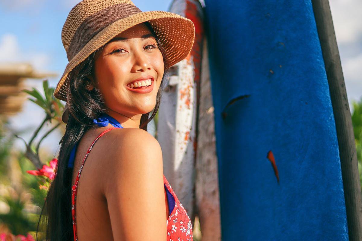 a woman wearing a hat and smiling