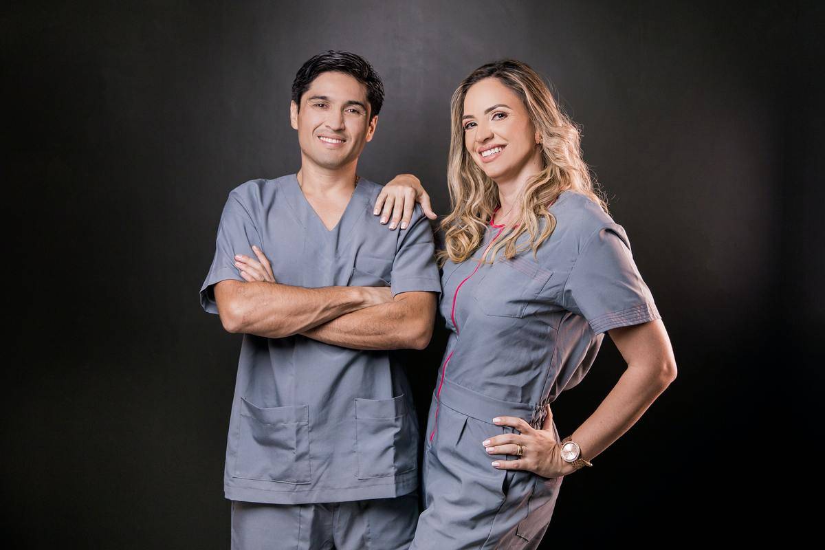 male and female doctors smiling for a photo