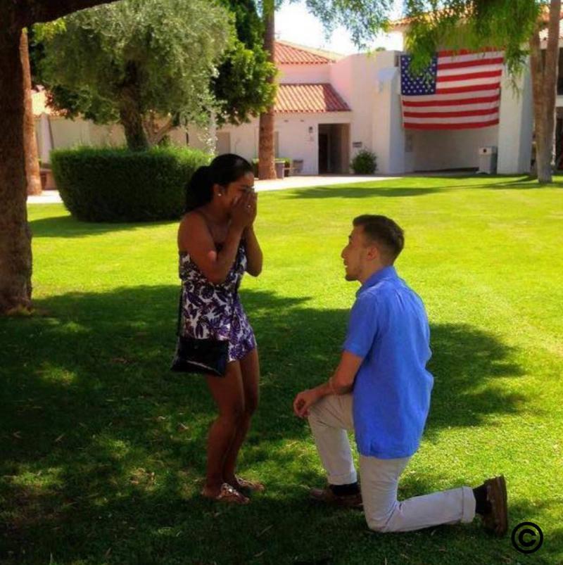 Erin on one knee proposing to Anie