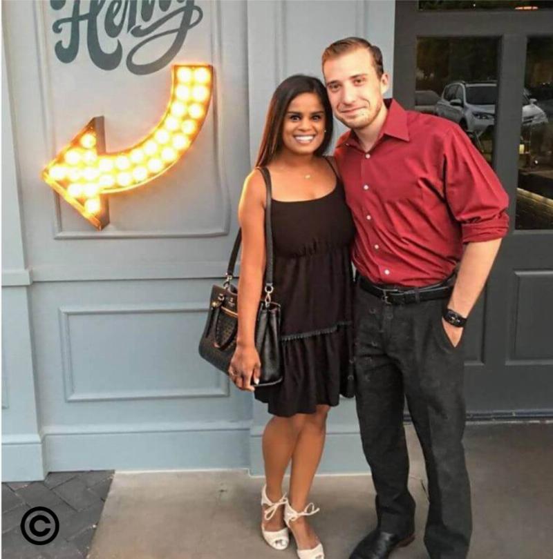 The couple standing outside a restaurant