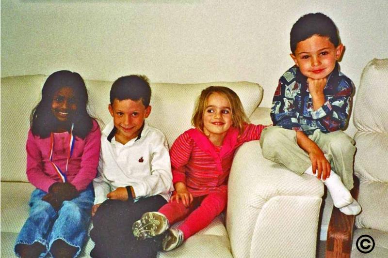 erin and annie with their friends sitting on a couch