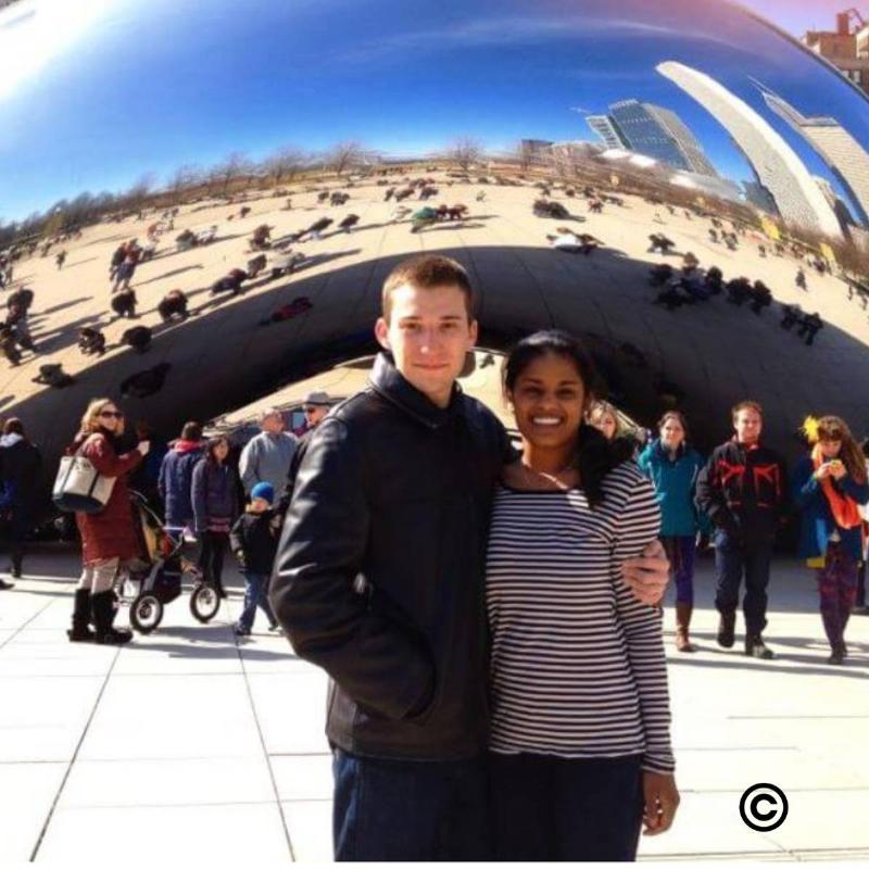 the couples in front of a zoo