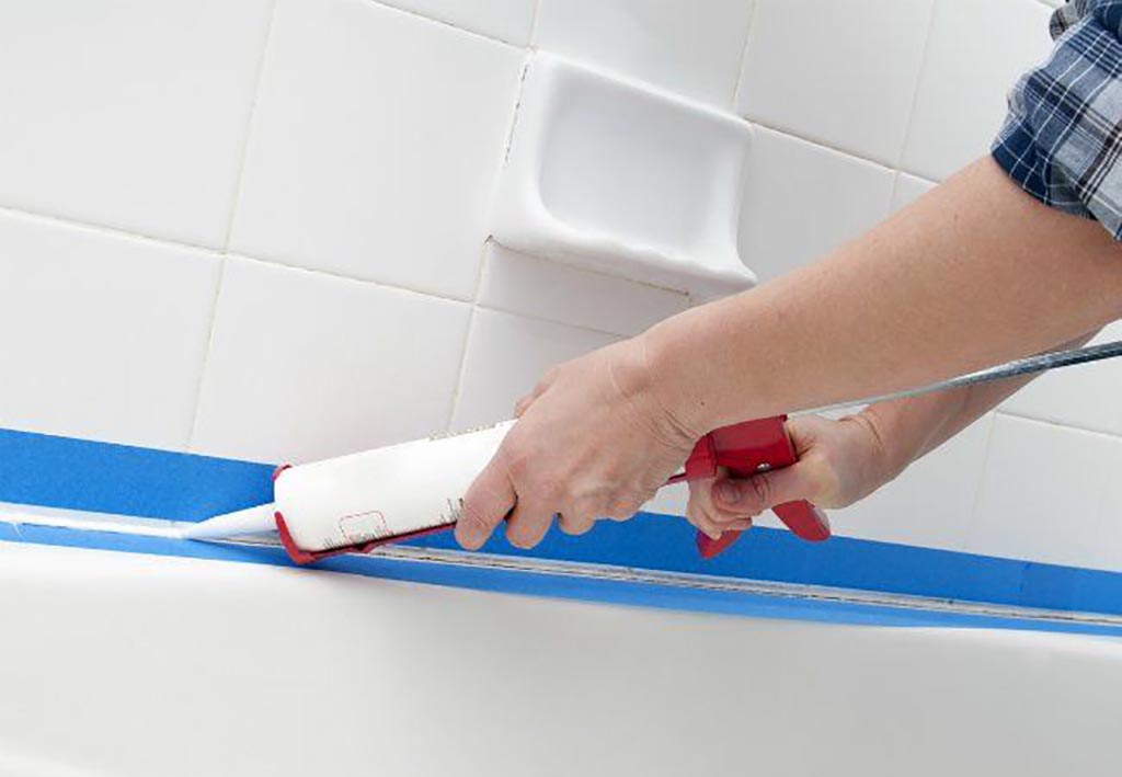 Person caulking bathroom
