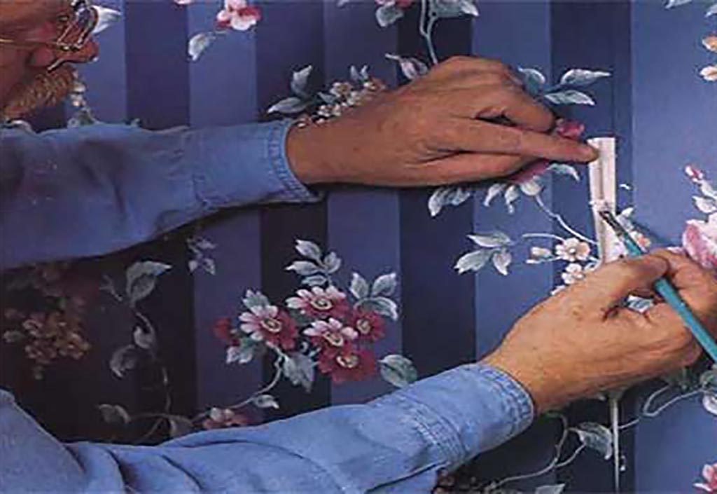 Man fixing wallpaper