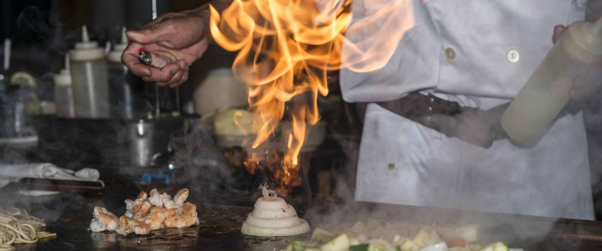 Hibachi teppanyaki style table food preparation in a Japanese steakhouse