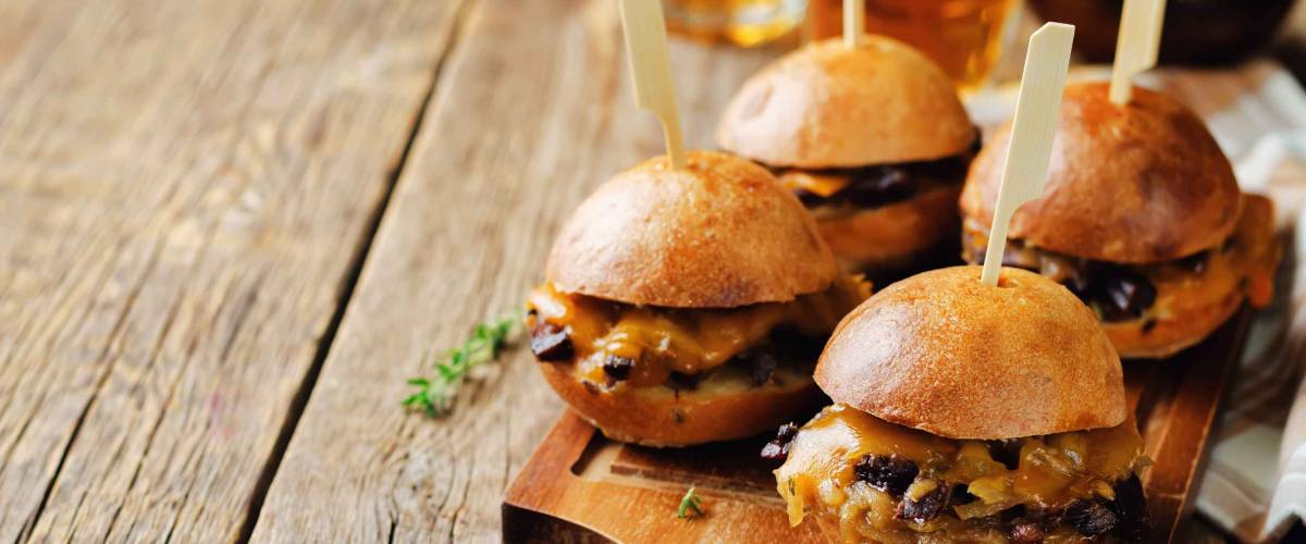 French Onion beef sliders with beer on a wood background. toning. selective focus